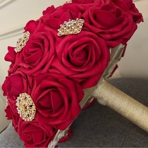 Red and gold brooch bouquet.